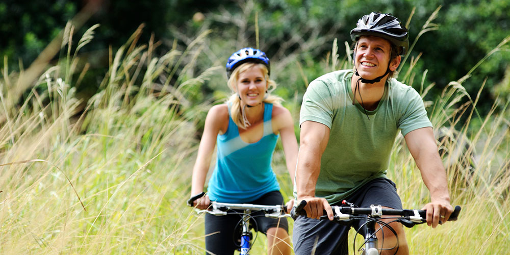 Healthy young couple cycling